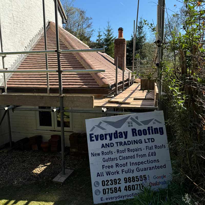 Completed red brown plain clay tile roof with third round hip tiles and lead flashing in Portsmouth