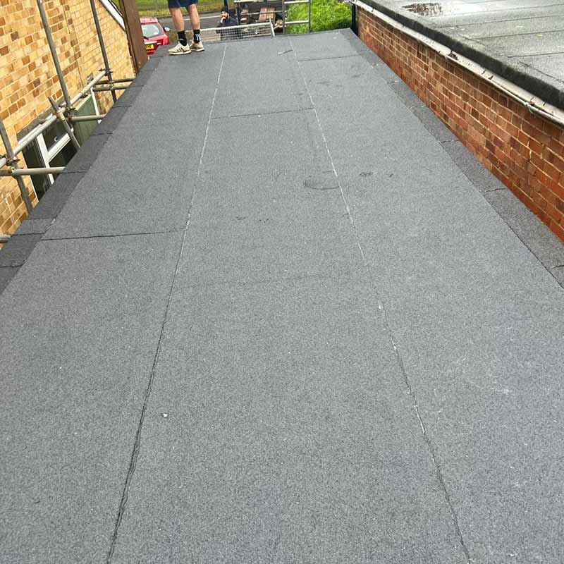 Completed grey felt flat roof in Portsmouth with neat sealed joints and edge detailing
