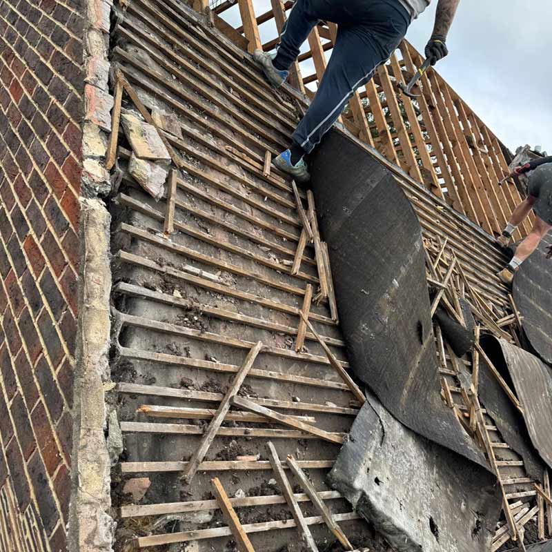 Old pitched roof being stripped before new roof installation in Portsmouth